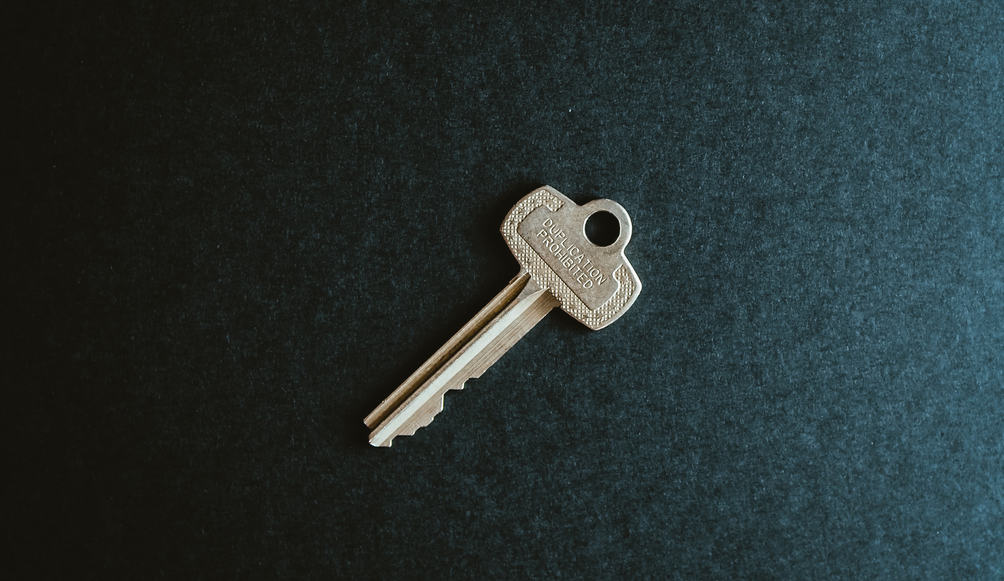 single key on a dark background