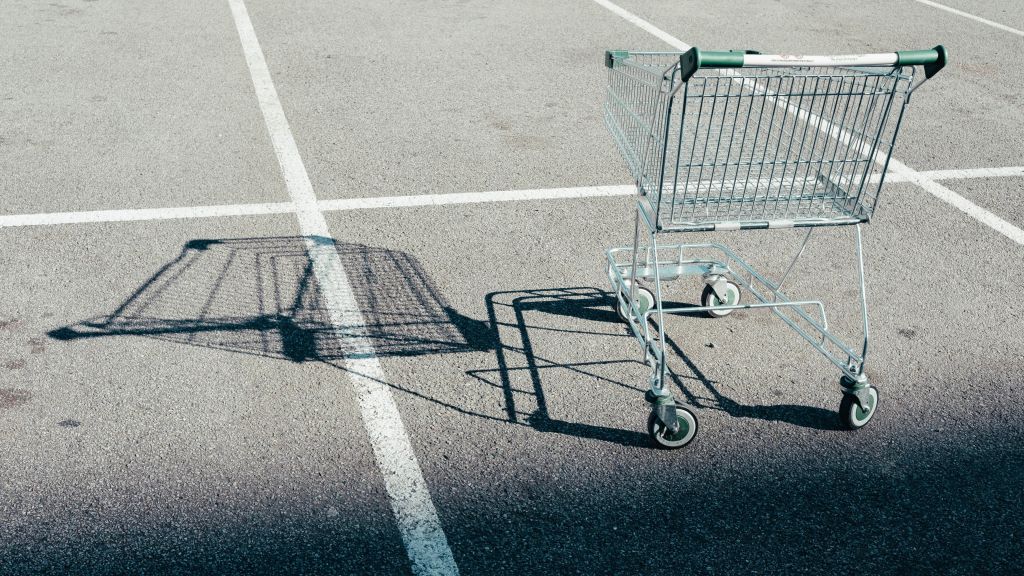 shopping cart with shadows in a parking lot