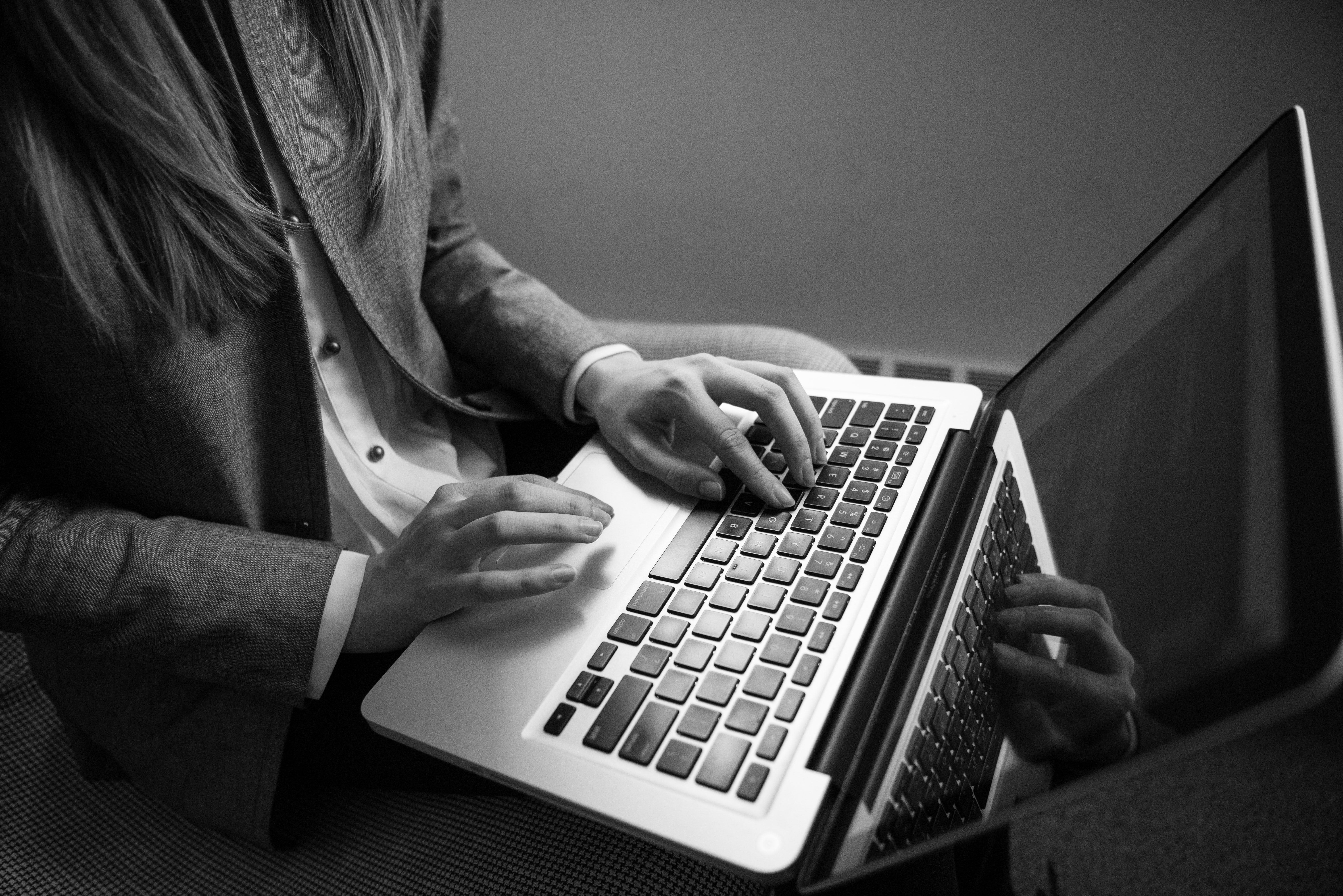 black and white photo man on laptop computer