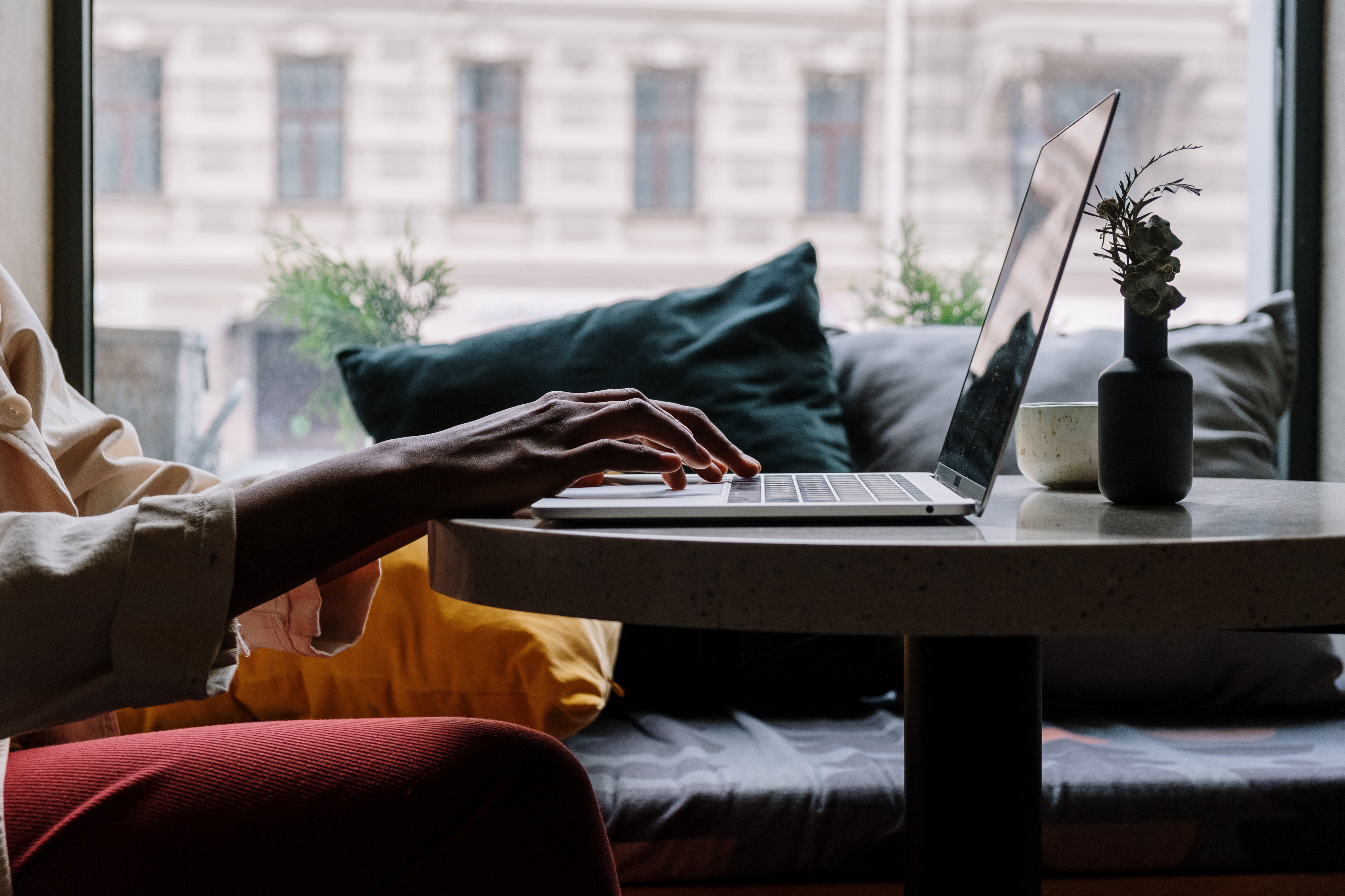 person tying on computer laptop