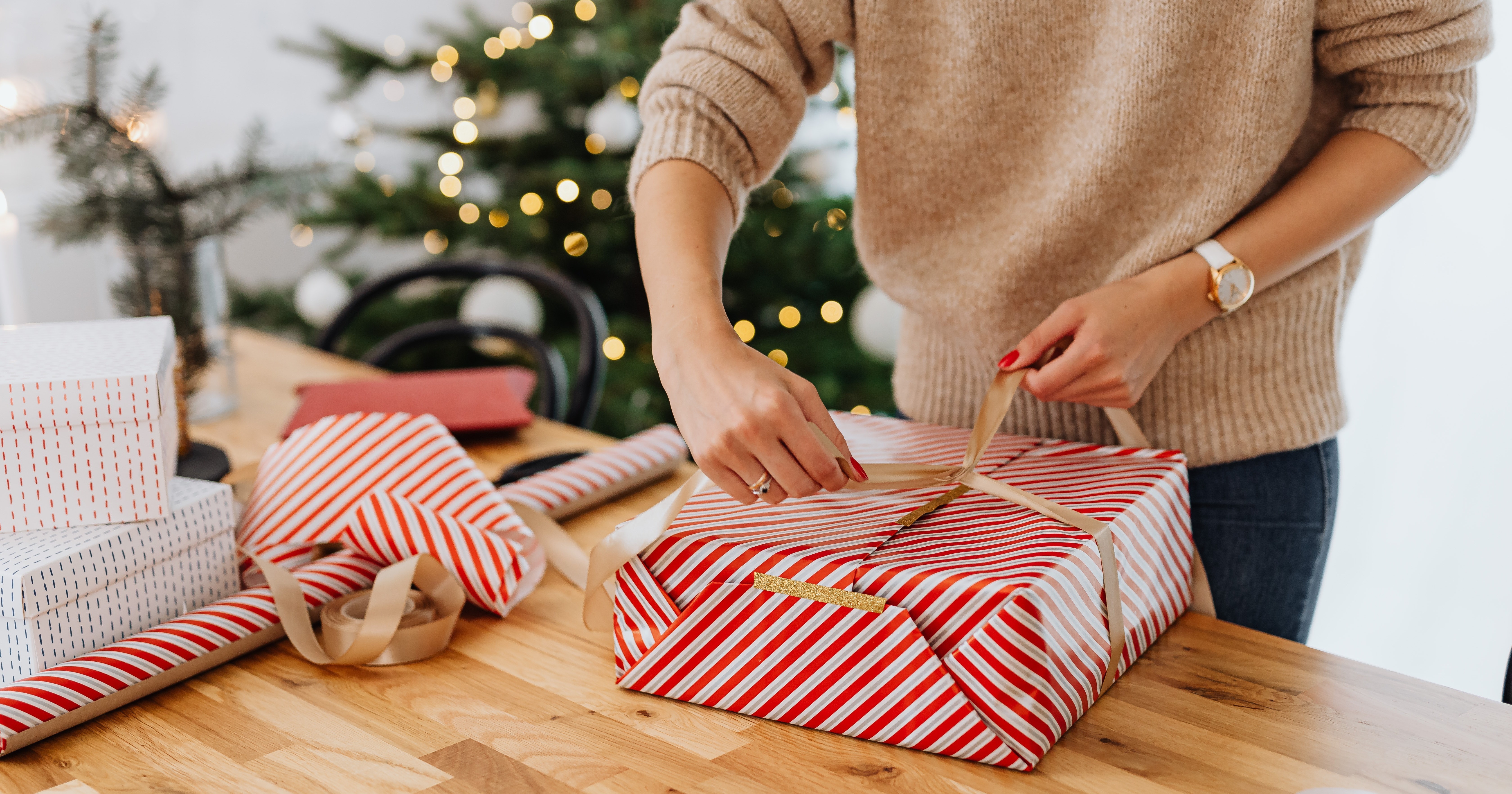 woman wrapping christmas gifts
