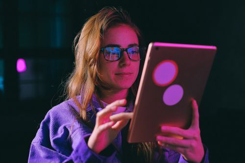 Woman completing a survey on an iPad