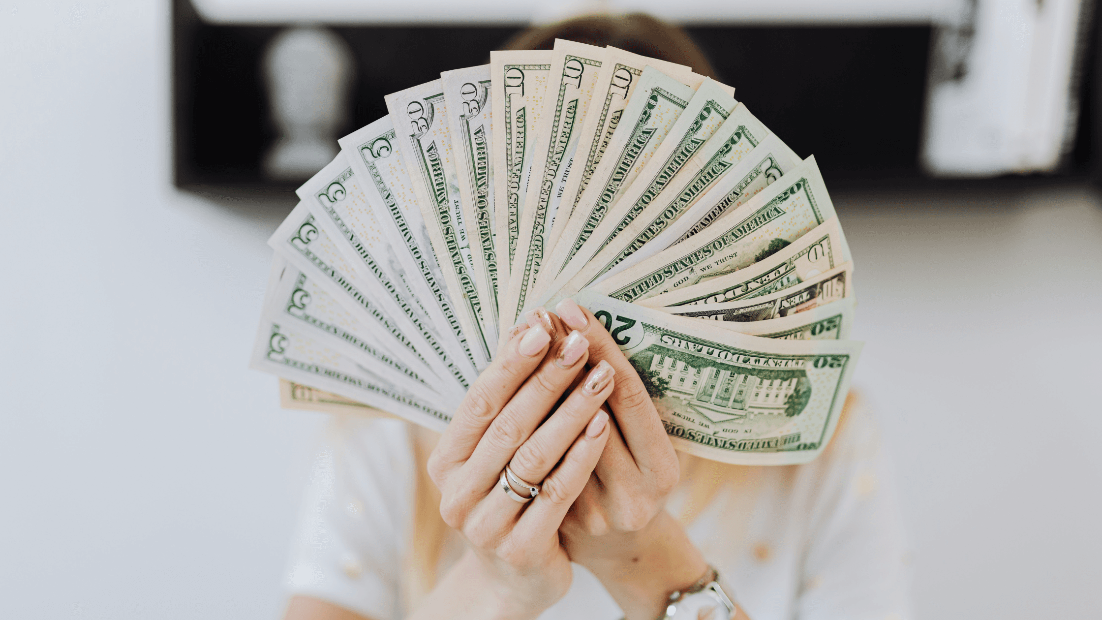 US dollars spread by hands