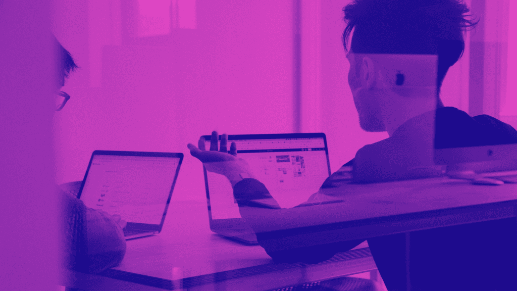 purple overlay over two people working on computers