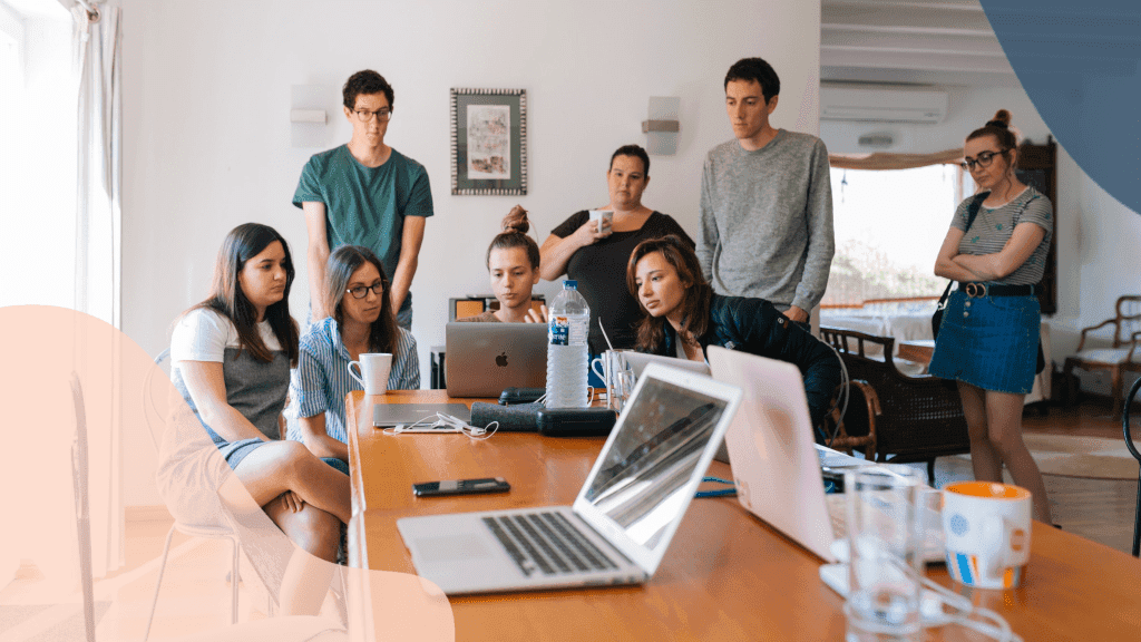 team gathering to look at lucky orange on a computer
